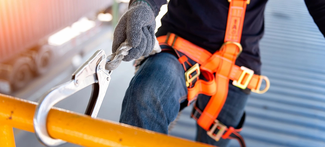 Construction worker in a safety harness.