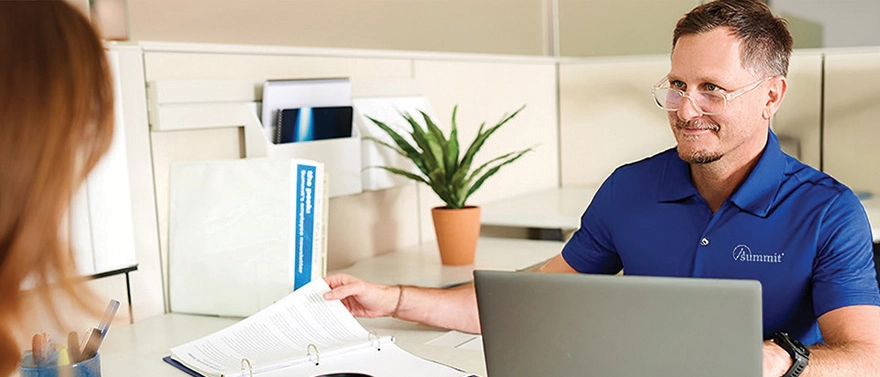 Summit premium auditor helps a client with an audit.