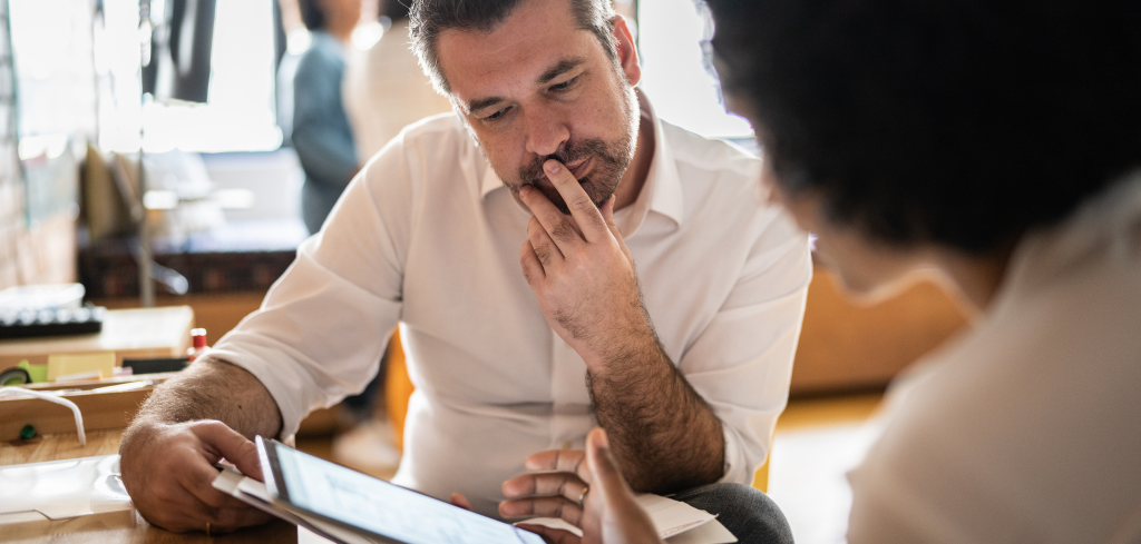 A man reviewing a document at his desk.