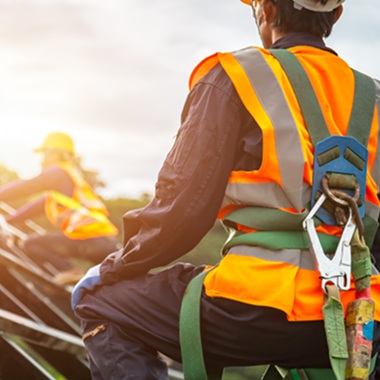 Roofing working in a safety gear.