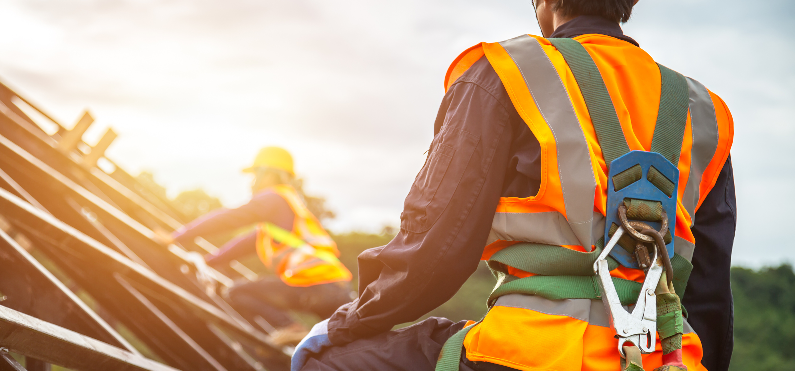 Roofing working in a safety gear.