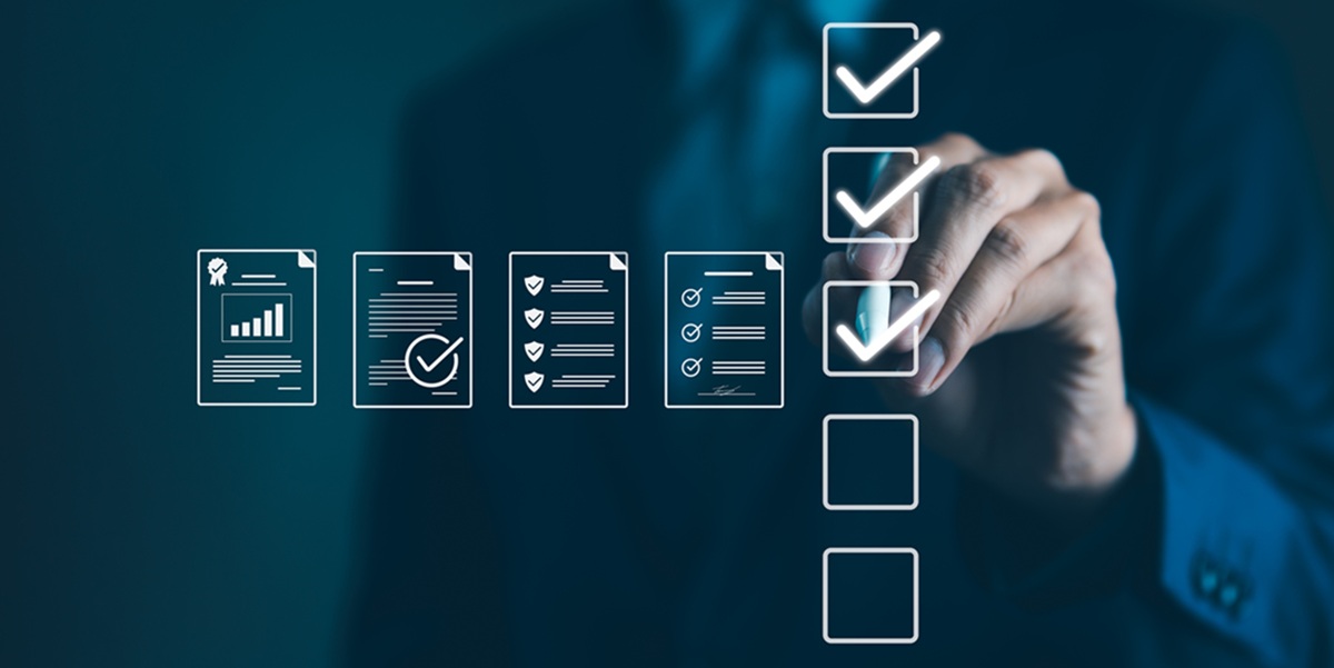Businessman marks off items on digital checklist.